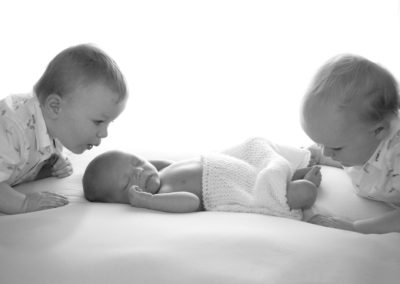 siblings with baby brother in photoshoot