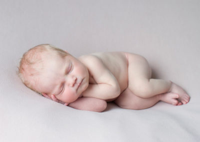 newborn baby side pose in photo session in Farnham