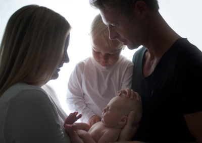family in photoshoot with baby newborn girl